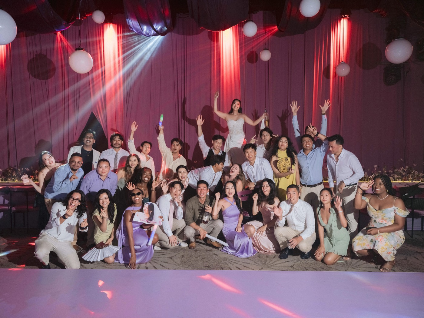 Wedding party posing together on the dance floor