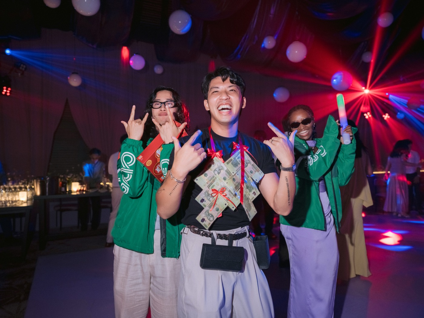 Guests celebrating with party props on the dance floor